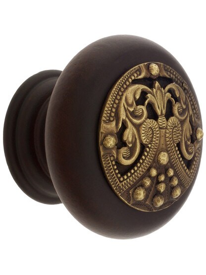 1 1/2 inch Diameter Regal Crest Knobs in Dark Walnut/Antique Brass.